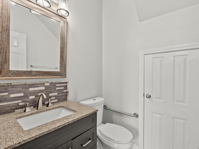 bathroom featuring decorative backsplash, vanity, and toilet