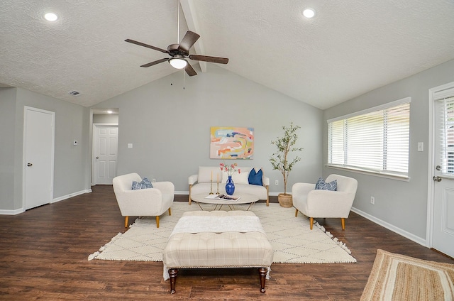 living area featuring wood finished floors, a textured ceiling, a ceiling fan, and baseboards