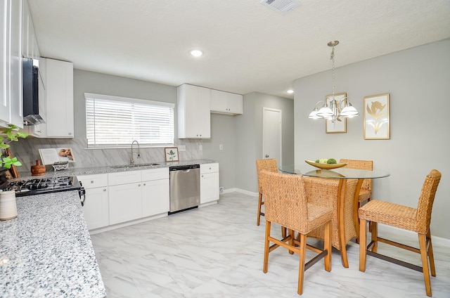kitchen with dishwasher, marble finish floor, a sink, and visible vents