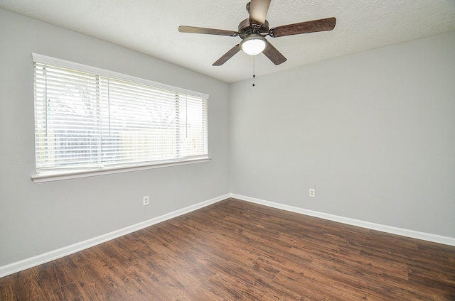 unfurnished room featuring baseboards, a textured ceiling, dark wood-type flooring, and ceiling fan