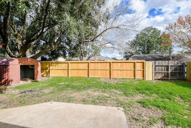 view of yard featuring a fenced backyard and an outbuilding