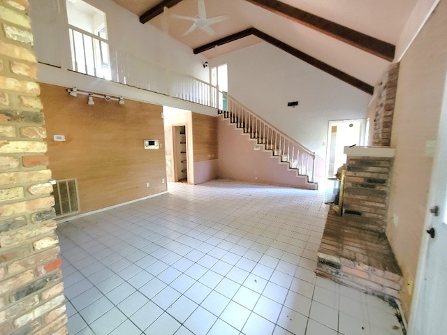 1601 15th St N, Texas City, TX 77590 - unfurnished living room featuring high vaulted ceiling, ceiling fan, beamed ceiling, stairs, and plenty of natural light