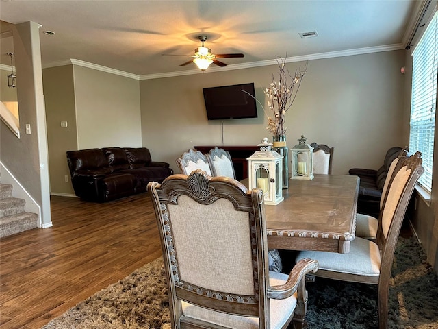 3110 Balch Springs Ln, Katy, TX 77449 - dining space featuring wood finished floors, ceiling fan, stairs, ornamental molding, and baseboards