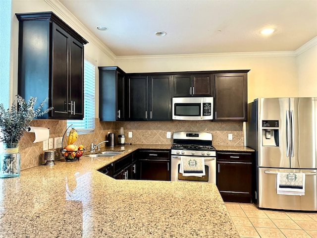 3110 Balch Springs Ln, Katy, TX 77449 - kitchen featuring stainless steel appliances, a sink, light stone countertops, crown molding, and tasteful backsplash