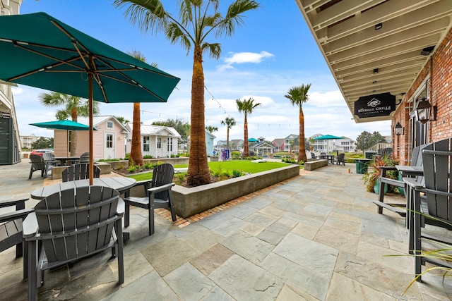 6 Compass Cir, Galveston, TX 77554 - view of patio / terrace featuring outdoor dining space and a residential view