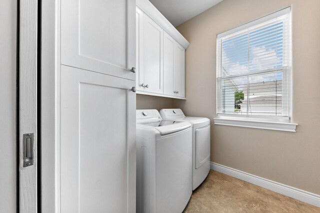 6 Compass Cir, Galveston, TX 77554 - clothes washing area with baseboards, cabinet space, and washer and clothes dryer