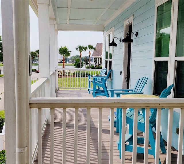 6 Compass Cir, Galveston, TX 77554 - wooden terrace featuring a porch
