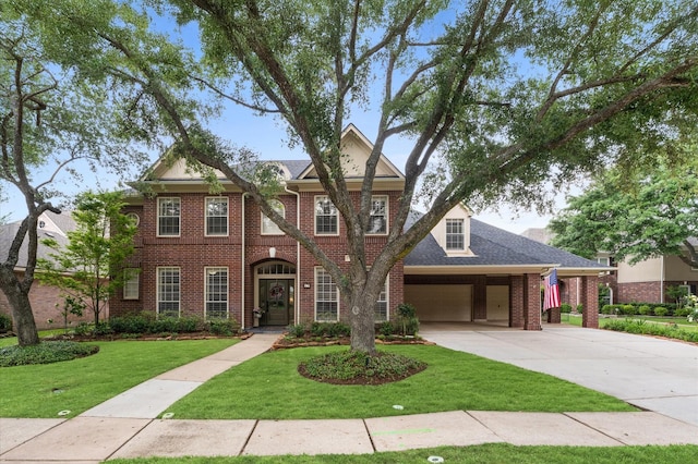 view of front facade featuring brick siding, a garage, driveway, and a front yard