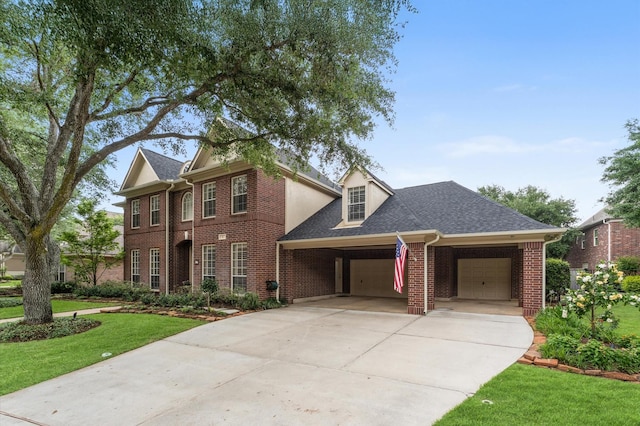 view of front facade with an attached garage, a shingled roof, brick siding, a front yard, and concrete driveway