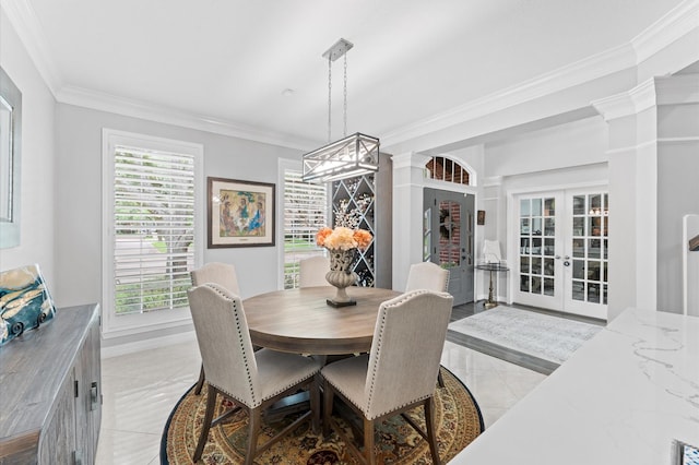 dining area featuring french doors, light tile patterned floors, baseboards, ornamental molding, and ornate columns