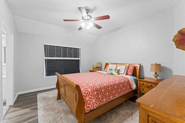bedroom featuring wood finished floors, baseboards, ceiling fan, and lofted ceiling