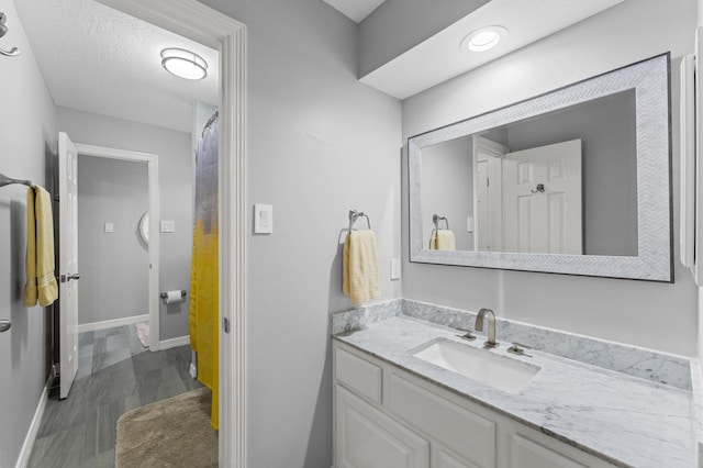 bathroom with vanity and baseboards