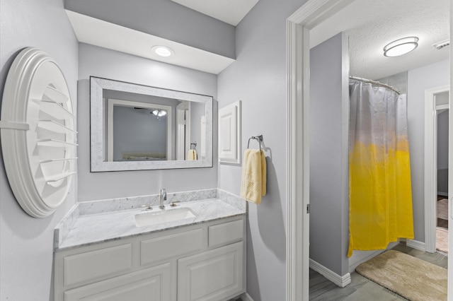 full bathroom featuring baseboards, vanity, curtained shower, and visible vents