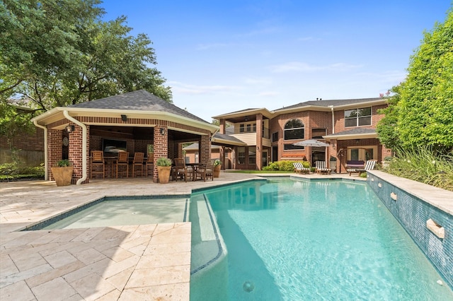 pool featuring a gazebo and a patio area