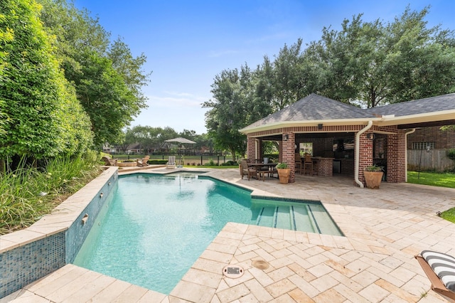 view of swimming pool featuring fence, outdoor dry bar, a gazebo, a fenced in pool, and a patio area