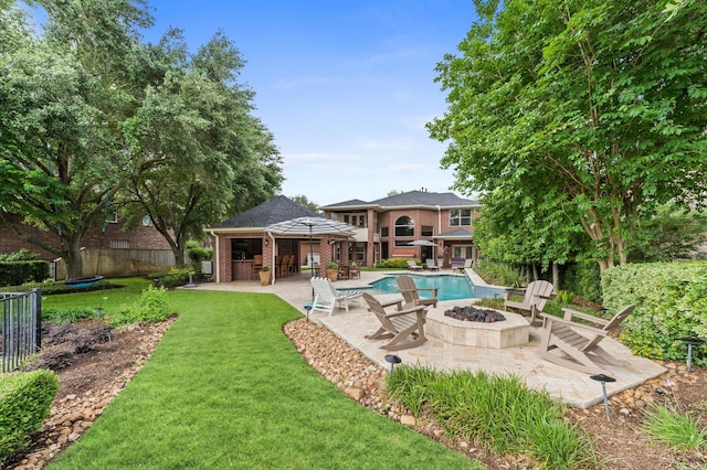 exterior space featuring a lawn, a patio area, a gazebo, fence, and a fire pit