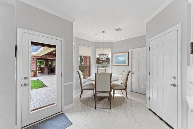 dining space featuring visible vents, crown molding, baseboards, light tile patterned floors, and a notable chandelier