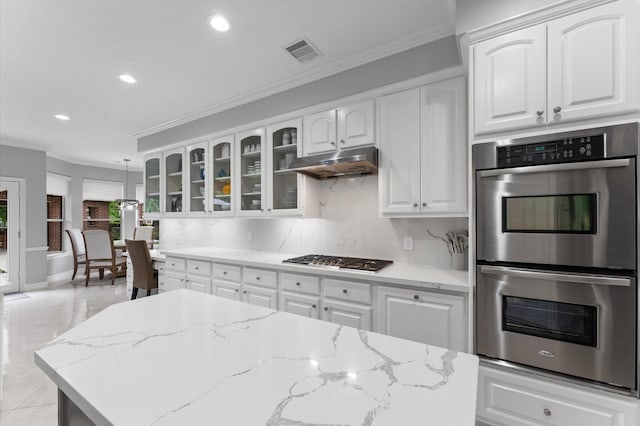 kitchen with crown molding, glass insert cabinets, under cabinet range hood, and stainless steel appliances