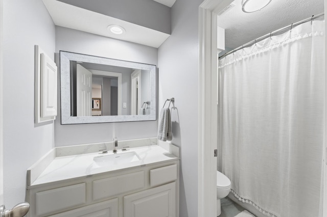 bathroom with vanity, a shower with shower curtain, and toilet