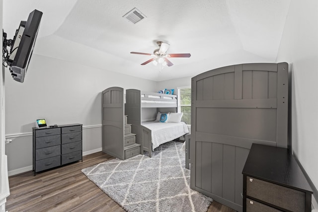 bedroom featuring baseboards, ceiling fan, wood finished floors, and visible vents