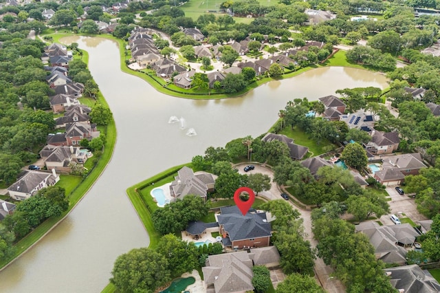 drone / aerial view with a water view and a residential view