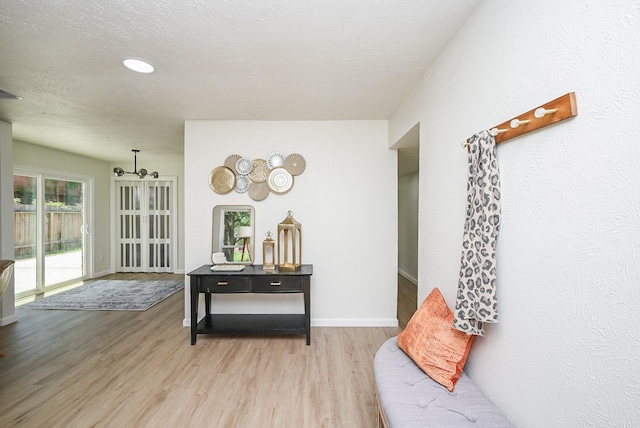 interior space with light wood finished floors and baseboards