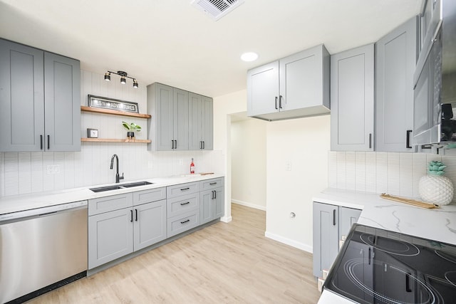 kitchen with decorative backsplash, dishwasher, a sink, and gray cabinets