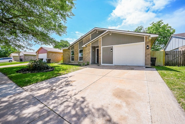 view of front of home featuring a front lawn, concrete driveway, fence, brick siding, and an attached garage
