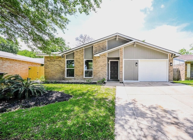 mid-century inspired home featuring brick siding, an attached garage, driveway, and a front lawn