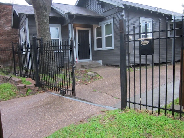 doorway to property featuring a gate and fence