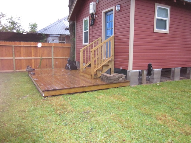 exterior space featuring entry steps, a lawn, and fence