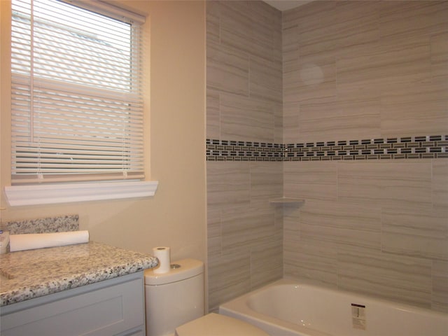 full bathroom with bathing tub / shower combination, vanity, and toilet