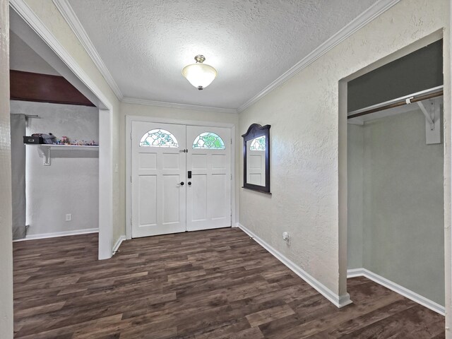 entrance foyer featuring ornamental molding, a textured ceiling, and plenty of natural light