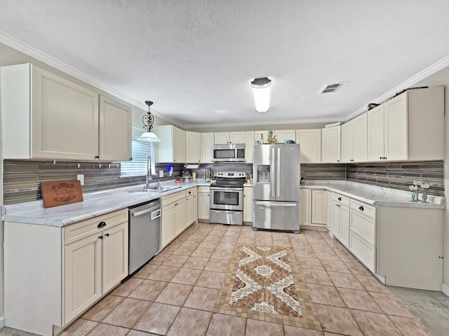 kitchen featuring visible vents, appliances with stainless steel finishes, decorative backsplash, and a sink