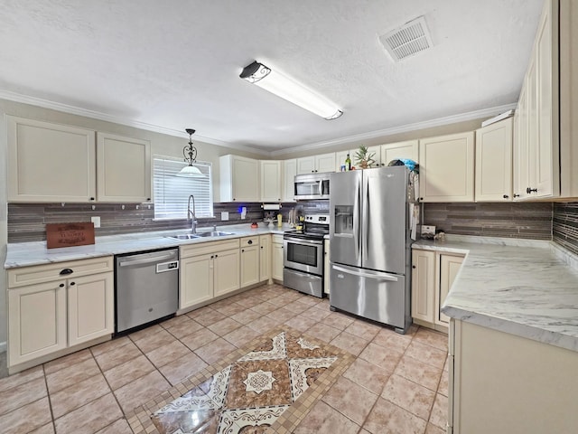 kitchen with visible vents, decorative backsplash, stainless steel appliances, and a sink