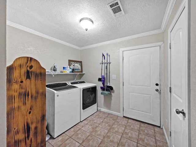 laundry area featuring laundry area, visible vents, light tile patterned floors, washing machine and dryer, and a textured ceiling