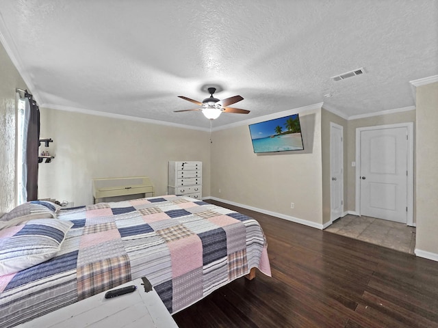 bedroom featuring a textured ceiling, wood finished floors, visible vents, and baseboards