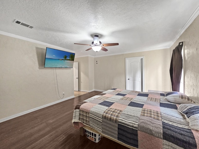 bedroom featuring a textured ceiling, wood finished floors, visible vents, and ceiling fan