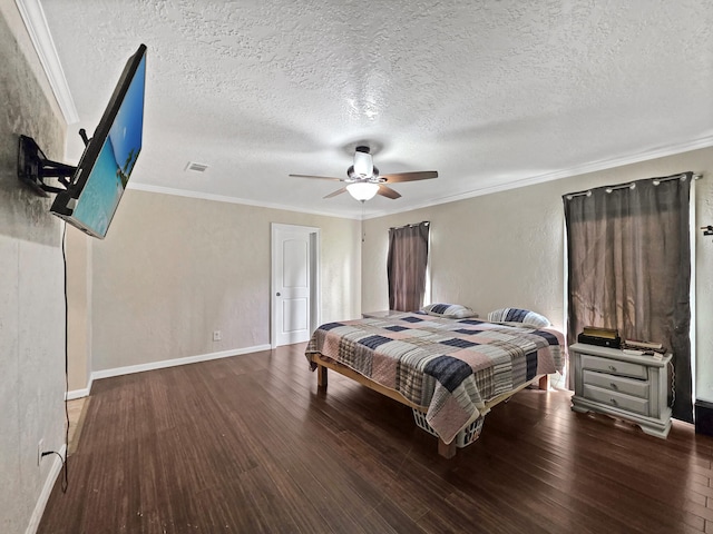bedroom featuring crown molding, wood finished floors, a textured ceiling, baseboards, and visible vents