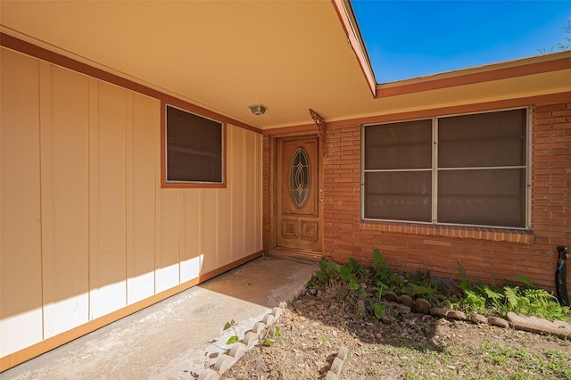 entrance to property with brick siding