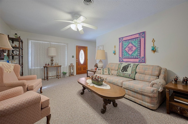 carpeted living room featuring a ceiling fan, a textured ceiling, and visible vents
