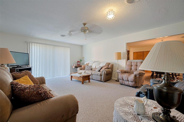 living room featuring carpet floors, a textured ceiling, and ceiling fan