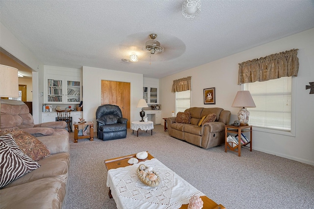carpeted living room featuring a textured ceiling and ceiling fan