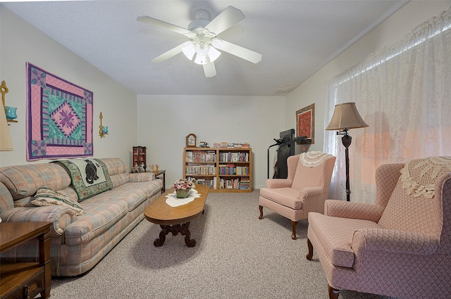 carpeted living area with ceiling fan