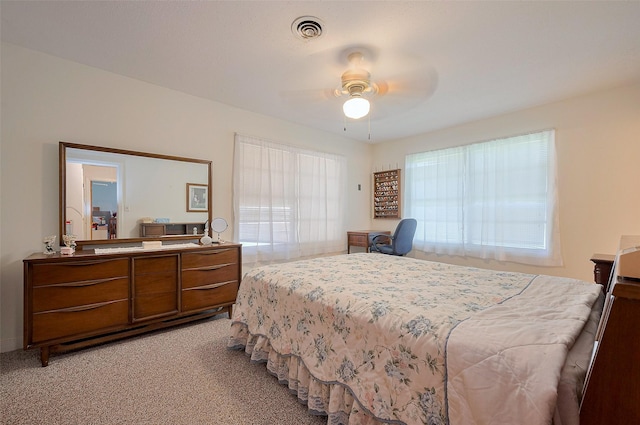 bedroom featuring light colored carpet, ceiling fan, and visible vents