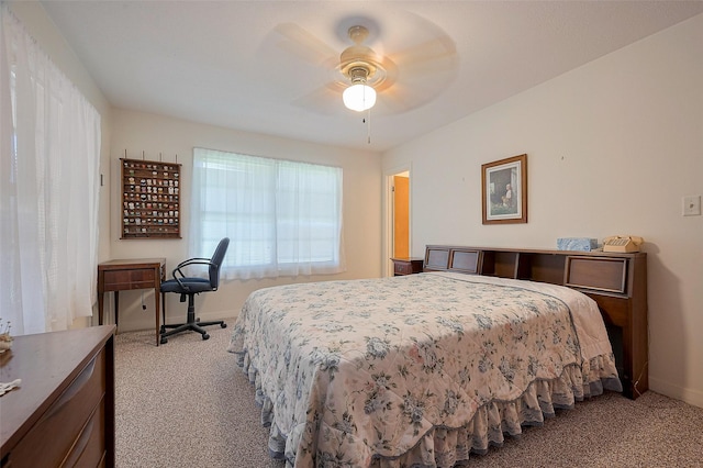 bedroom featuring ceiling fan, baseboards, and carpet