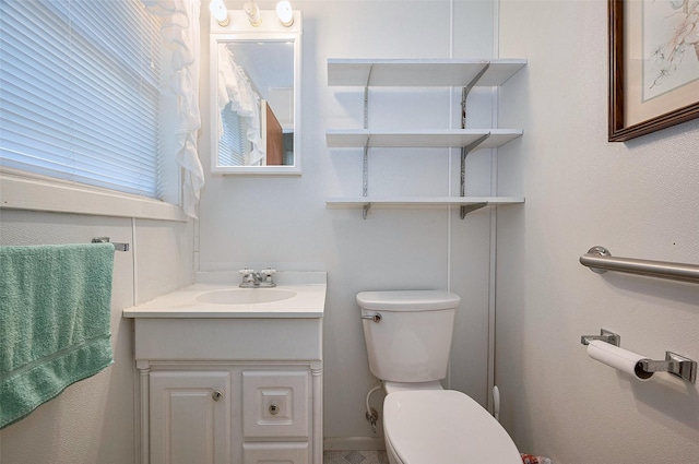 half bathroom featuring toilet and vanity