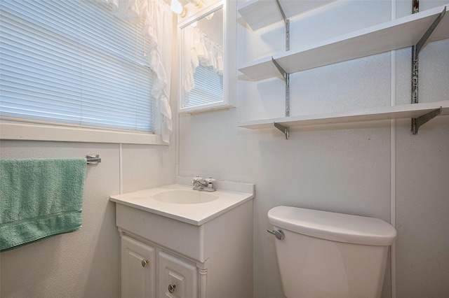 bathroom featuring toilet and vanity