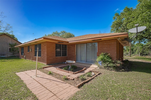 view of front of property featuring a front lawn and brick siding
