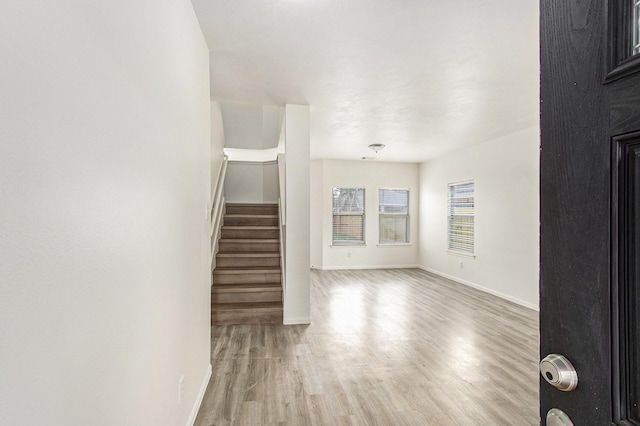 1722 Caldbeck Ln, Fresno, TX 77545 - unfurnished living room featuring baseboards, wood finished floors, and stairway